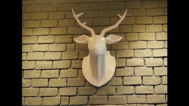 Low poly wooden sculpture of deer trophy head 
